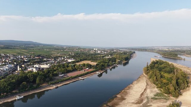 Drone aerial panorama of R&uuml;desheim am Rhein, Germany, featuring the historic riverside town, vineyards and the Rhine River under a clear summer sky. Scenic view of the famous wine region in the UNESCO