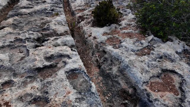 Ancient Cart Ruts on Xemxija heritage trail, parallel cartways groves cut into bare rock.