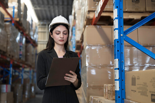 Warehouse, deposit or store. Warehouse worker checking incoming items, reporting broken or missing goods in warehouse