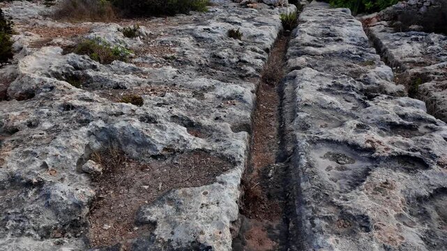 Ancient Cart Ruts on Xemxija heritage trail, parallel cartways groves cut into bare rock.