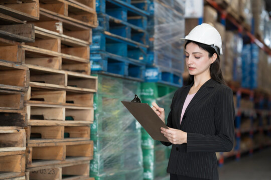 Warehouse, deposit or store. Warehouse worker checking incoming items, reporting broken or missing goods in warehouse