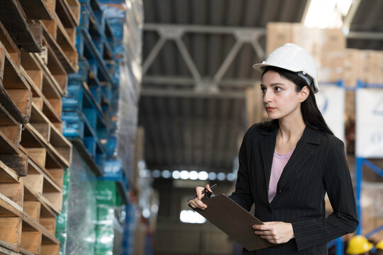 Warehouse, deposit or store. Warehouse worker checking incoming items, reporting broken or missing goods in warehouse
