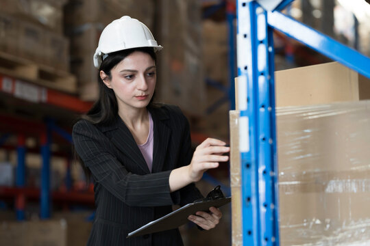 Warehouse, deposit or store. Warehouse worker checking incoming items, reporting broken or missing goods in warehouse