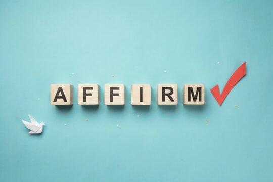 Affirm word spelled with wooden blocks and red checkmark on blue background top view flat lay concept