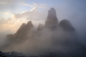 Majestic jagged peaks emerging from dense fog. Ideal for themes of mystery, achievement, growth, and tranquility. Copy space included. © marcodenaro