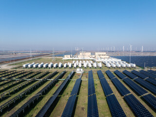 Large scale photovoltaic power station with energy storage containers under blue sky © zhu difeng