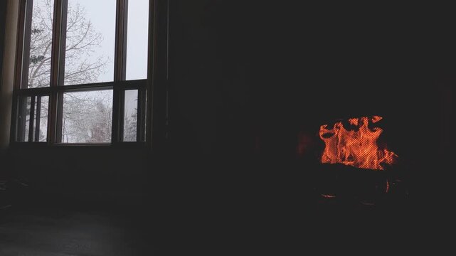 Warm Cozy Fireplace with Burning Firewood and Glowing Flames in Rustic Stone Hearth During Winter. Perfect for winter, home comfort, holiday, Christmas, and cozy living room background videos