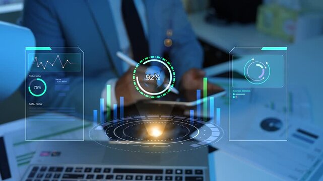 Holographic business analyst using digital dashboard with glowing charts and data graphs above a tablet in a modern office, Business analytics, finance, technology, and performance monitoring