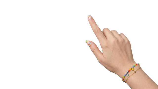 Close-up female hand raising one index finger in an upward pointing gesture, featuring playful multicolor nail art and a delicate bead bracelet on transparency PNG asset