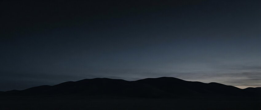 Minimalist Mountain Range Silhouette at Twilight, Dark Sky Background for Website Banner and Marketing Template