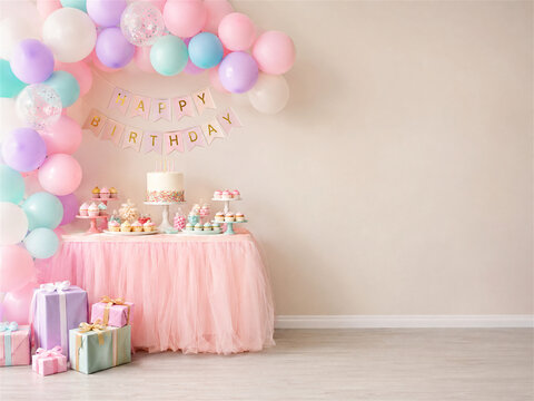 Pastel birthday party setup with colorful balloons a pink dessert table wrapped gifts a small cake and open wall space creating a cheerful celebration scene for a child or special event