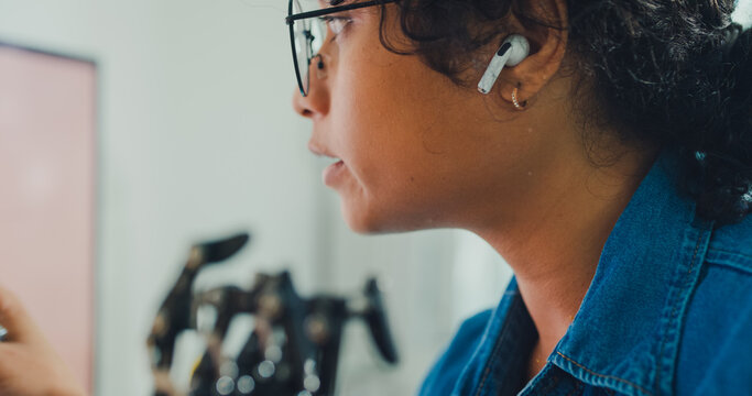 Close-up African American female robotics engineer discussing mechanical part on video call in laboratory. Remote work, virtual training, online meeting, future technology, technical support concept.