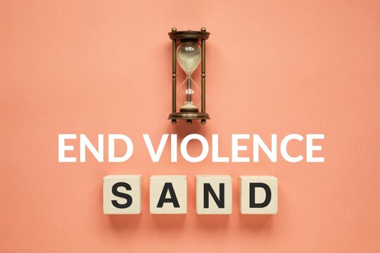Urgent call to end violence, featuring an hourglass and 'SAND' to signify time running out, set on a pink background, promoting critical social change and awareness