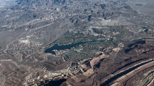 4k aerial video footage of area around Lake Las Vegas, located in Henderson, Nevada, with infrastructure, Golf Courses, Resorts and many houses, surrounded by hilly desert landscape - Las Vegas Valley
