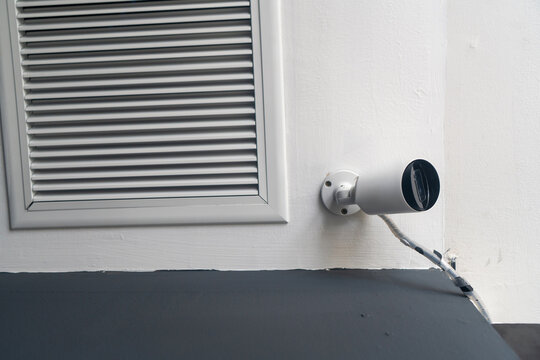 White wall vent with cylindrical object near baseboard