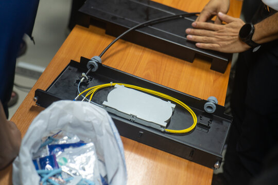Technician Installing Fiber Optic Cable on Patch Panel