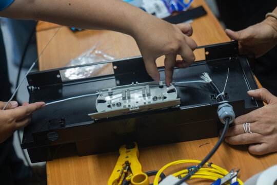 Technical workers assembling electrical testing equipment