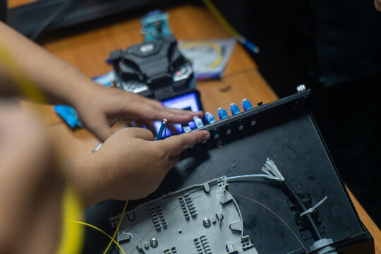 technician inspecting and repairing electronic circuit board