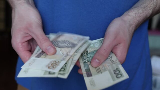 Hands Counting Polish Zloty Notes