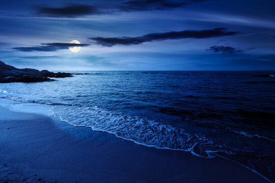 black sea landscape in summer at night. full moon over bulgaria nature landscape with sandy beach. mysterious summer vacation at the sea shore concept. waves and empty beach. remote vacation scene