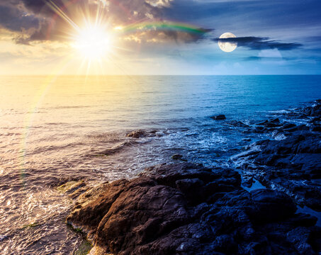 sea coast with stones and rocks. day meet night. summer vacation background at twilight. sun and moon in harmony over seascape with rough terrain. relaxing at the sea. coast of bulgaria wallpaper