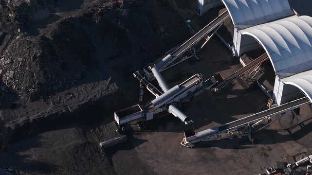 Aerial view of heavy machinery processing coal in a mine