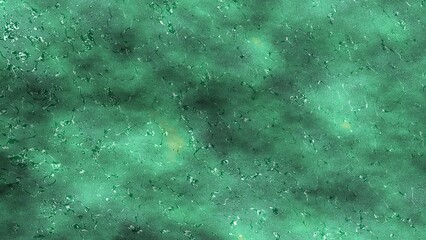 Abstract emerald green liquid glass texture with wavy rippled metallic surface reflection background © Fatema SF