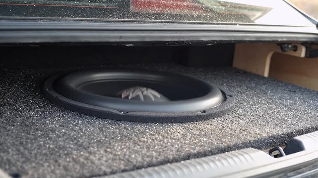 Open Car Trunk Revealing Custom Installed Heavy Bass Subwoofer Audio Speaker System And Carpeted Enclosure