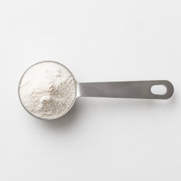 Tablespoon of white powder on white background