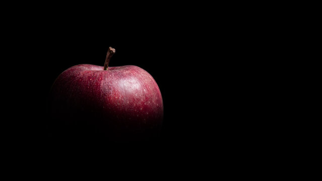 Fresh Red Apple with Dramatic Low Key Lighting on Black Background