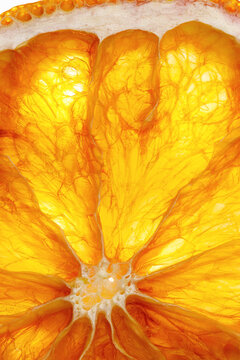 Extreme macro view of orange cross-section with beautiful radial pattern of flesh and seeds. Natural oranges fruit yellow abstract natural texture for backgrounds, botanical art, and design concepts.