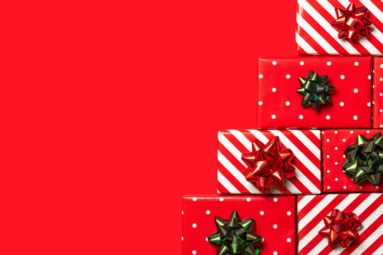 Festive Christmas background with stacked red and white gift boxes on the right and large copy space. Ideal for cards, banners, invitations, social media and holiday advertising.