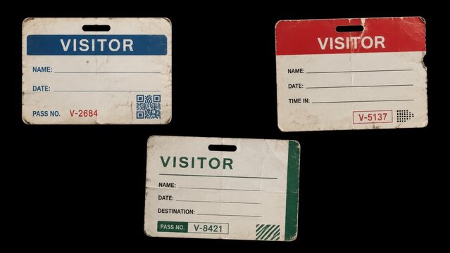 Three worn visitor identification badges isolated on black