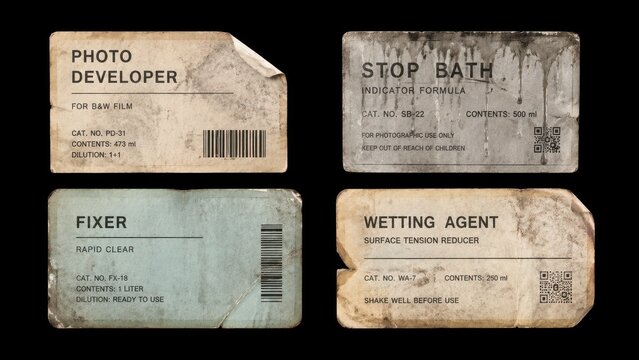 Set of distressed vintage darkroom chemical labels on black