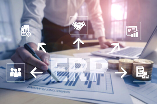 Business Professional Working on ERP System Implementation with Charts and Data Analysis in Modern Office Environment Highlighting Collaboration and Efficiency. Glyphic.