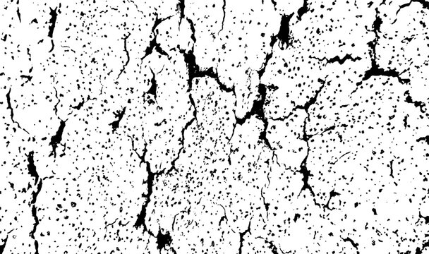 Cracked textured surface with granular speckles and dark fissures during harsh lighting