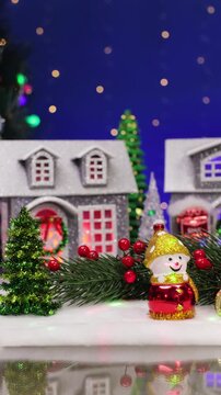 A decorated Christmas town with letters and a red car in the foreground