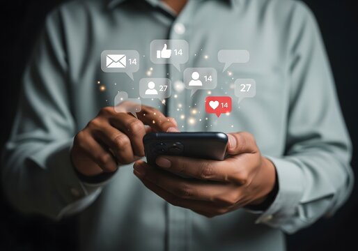 Close up of a person using a smartphone with social media notification icons floating above