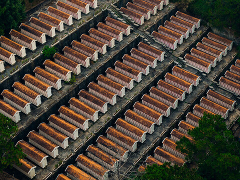 Rows of tomb structures aligned in terraced hillside cemetery Da Lat Vietnam