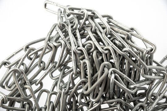 A pile of silver metal chains on a white background.