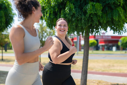 Diverse women running together embracing body positivity
