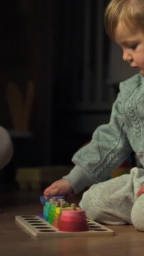 A mother and child sit together on the living room floor, assembling a colorful educational toy with building blocks on a soft carpet, part of family learning in a brightly lit domestic setting