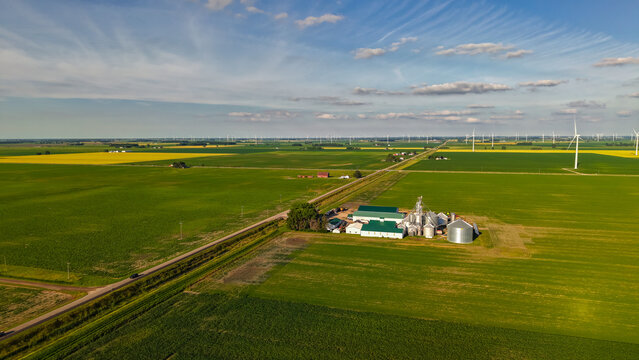 Rural farm fields with wind turbines producing renewable energy
