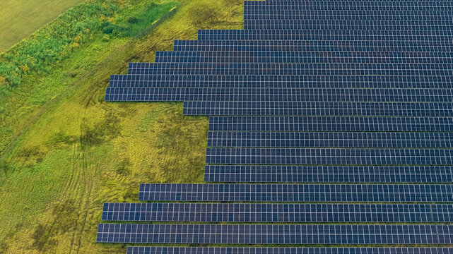 Solar farm generating clean renewable energy on green field