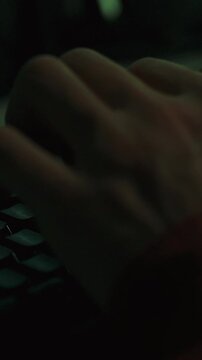 A programmer's hands type rapidly on a keyboard in dim lighting, entering code and data for a software development process. Late-hour focus and intense concentration are present in the quiet office