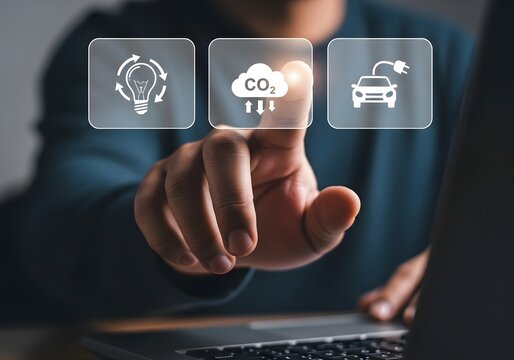 Person using a laptop to select sustainable energy and carbon reduction icons for the future
