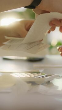 Two people sit at a well-lit table in a bright office sorting papers and other materials, a project manager guides the collaboration, exchanging documents and resources as they organize the project