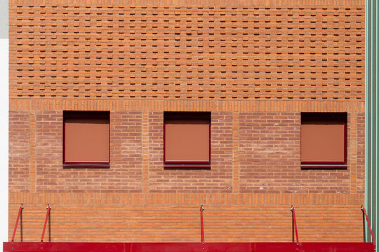 Modern brick building facade with unique patterns and windows
