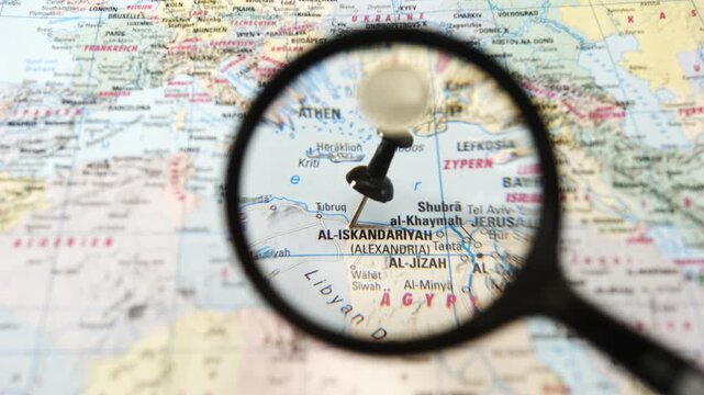 Exploring Al-Iskandariyah with a magnifying glass on a map