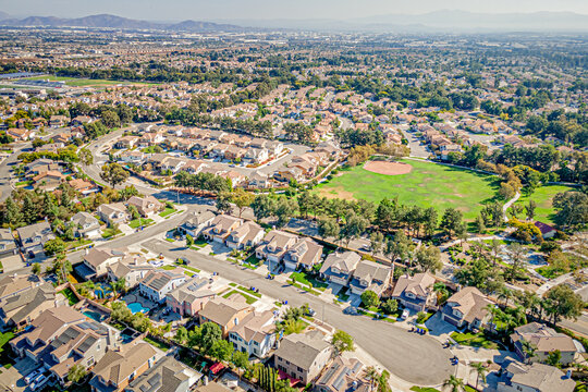 Rancho Cucamonga, California, CA October 8, 2024: High Aerial City Drone View toward Kenyon Way, Highland Ave Community with Homes, Houses, Townhomes, Streets, Roads, Mountain, and Kenyon Way Park
